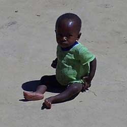 Child sitting in sand